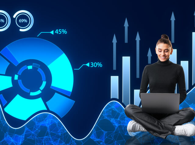 Happy young woman with laptop and creative digital business pie chart on dark background. Glowing stock market analysis and big business data analysis.